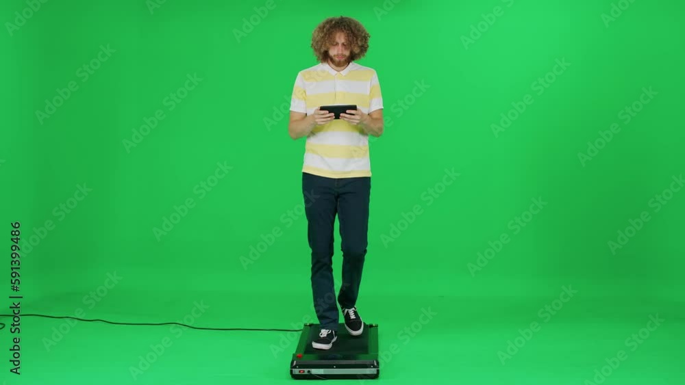 Passer-by man in walking on a green background and uses a screen tablet, man enjoy a walk and works, template on a chromakey. Passer-by man in walking on a green background and uses a screen tablet, man enjoy a walk and works, template on a chromakey.