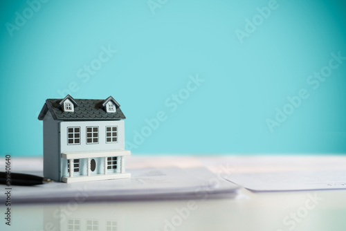 Property investment concept, image of small house model on the table..