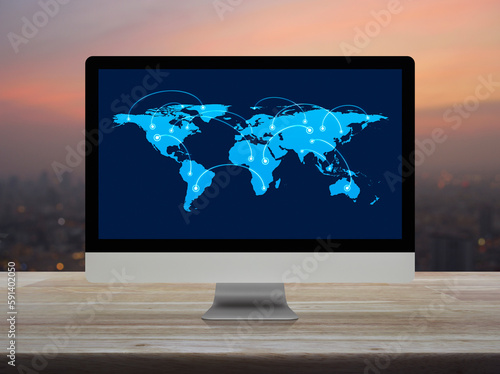 Connection line with global world map on desktop computer monitor screen on table over blur of cityscape on warm light sundown, Business communication online, Elements of this image furnished by NASA