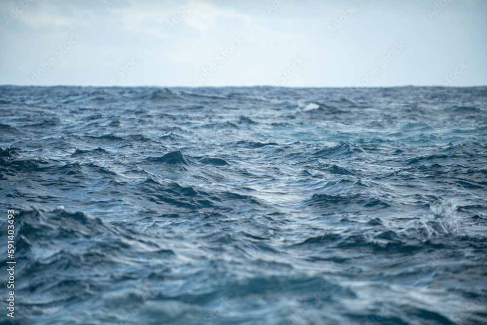 Calm sea water surface texture with splashes and waves. Abstract nature background. Background of aqua ocean water surface. Calm sea water surface texture with splashes and waves. Abstract nature background. Background of aqua ocean water surface.