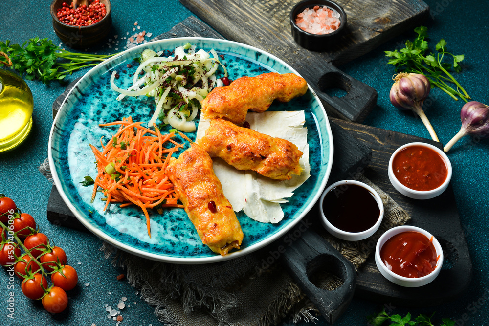 Grilled chicken Lula kebab with onions and pita bread. Azerbaijani cuisine. Free space for text. Close up.