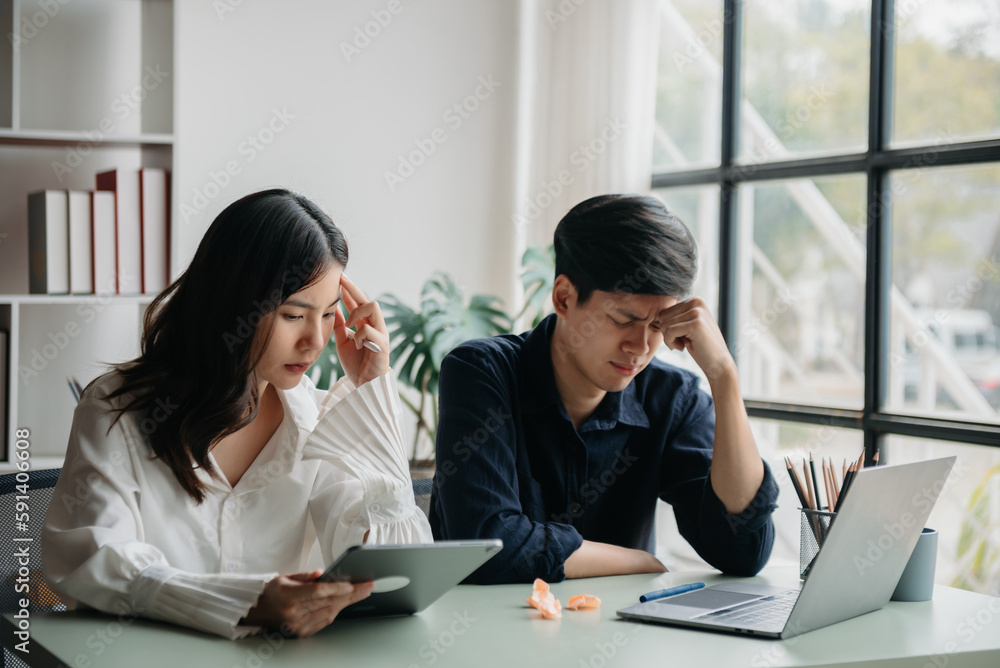..Furious two Asian businesspeople arguing strongly after making a mistake at work in office ..Furious two Asian businesspeople arguing strongly after making a mistake at work in office