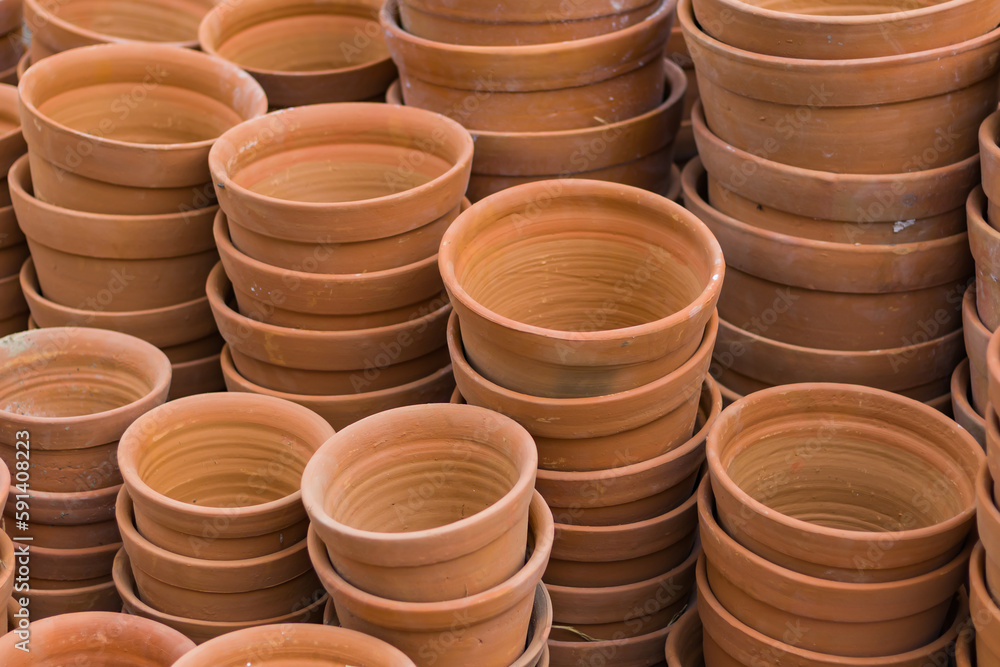 Clay pots or tubs for gardening stacked together. Terracotta pots are essentials for home balcony gardens. Product from pottery industry. Clay pots or tubs for gardening stacked together. Terracotta pots are essentials for home balcony gardens. Product from pottery industry.