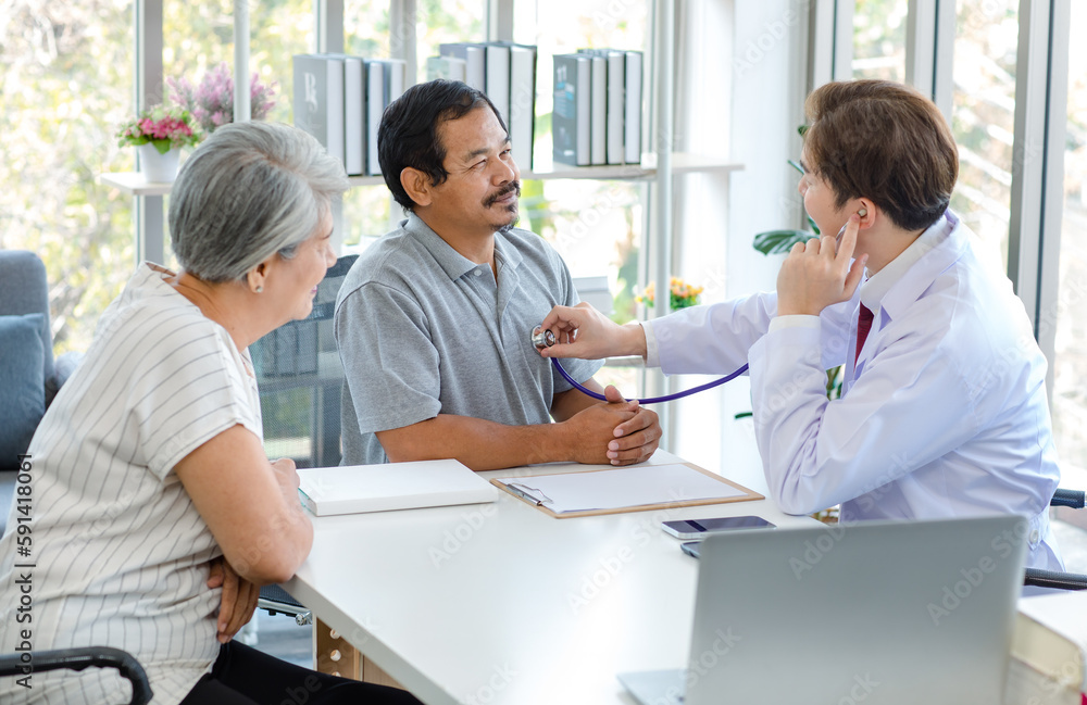 Asian professional successful male doctor in white lab coat with stethoscope hold medicine pill bottle showing explaining dosage and usage to elderly old senior patient and cousin in hospital office Asian professional successful male doctor in white lab coat with stethoscope hold medicine pill bottle showing explaining dosage and usage to elderly old senior patient and cousin in hospital office