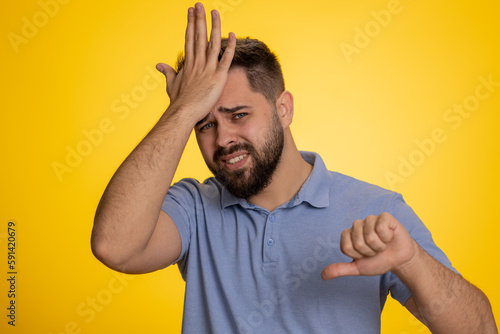 Obraz na plátně Bearded caucasian man feeling hopelessness loneliness, nervous breakdown, loses becoming surprised by lottery results, bad fortune loss, unlucky news