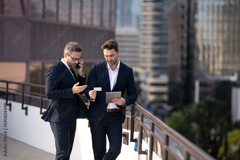 Business man in Ney York. Business men team using tablet laptop outdoor. Businessmen looking tablet with business success in city. Business man in Ney York. Business men team using tablet laptop outdoor. Businessmen looking tablet with business success in city.