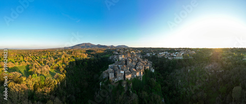 Obraz na płótnie View from above, stunning panoramic view of the village of Vitorchiano at sunset. Vitorchiano is a medieval Italian village in Viterbo Province, Lazio, Italy. w salonie