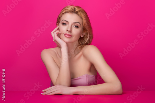 Beauty face of young blonde woman. Sexy model posing in studio. Portrait of beautiful girl. Beauty woman face closeup. Pretty girl face on studio background. Sensual look. Beautiful female face.