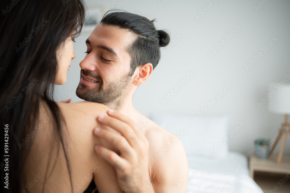 Fototapeta premium Gorgeous sexy couple enjoying sex in the house's bedroom, Concept of as emotional relationships passion and love