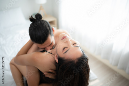 Gorgeous sexy couple enjoying sex in the house's bedroom, Concept of as emotional relationships passion and love
