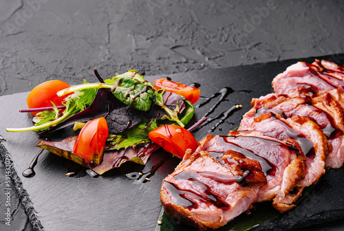 Japanese tataki beef filet with lettuce and tomatoes photo