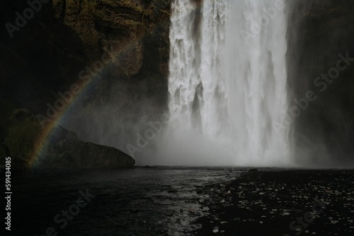 Beautiful view of a rainbow against a waterfall