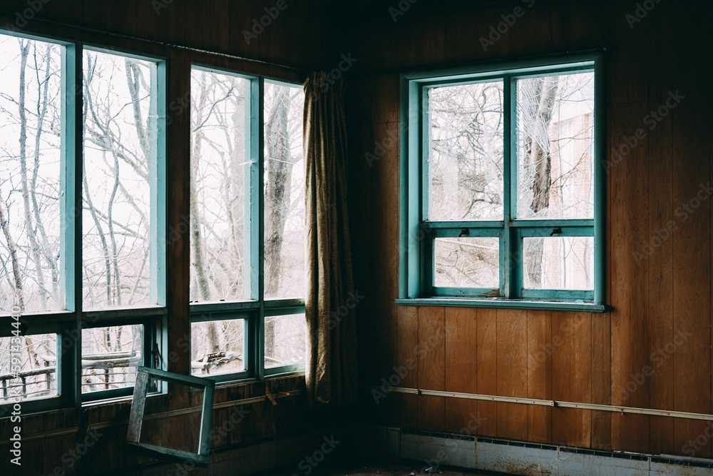 Fototapeta premium Interior of an abandoned building with broken windows