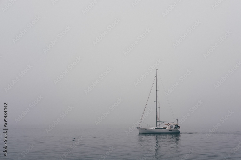 Beautiful view of the sea in cloudy weather with a white boat on it