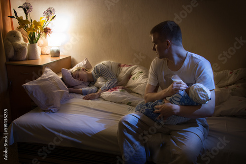 The husband feeds the child at night so as not to wake up the sleeping wife