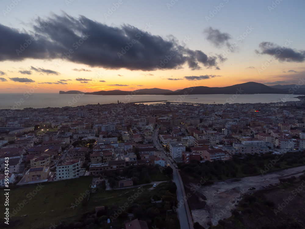 Aerial view of dark clouds over Alghero at sunset