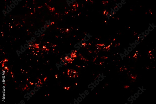 Closeup of red hot sparks isolated on a dark background