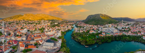 Aerial view of city of Mostar in Bosnia and Herzegovina and it's landmarks (Neretva river, Old bridge, Koski Mehmed Pasha Mosque).