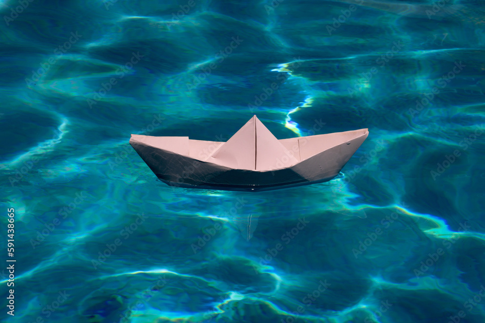Paper boat on the sea background. Tourism, travel dreams vacation holiday. Cruise ship concept. Origami paper sailing boat.