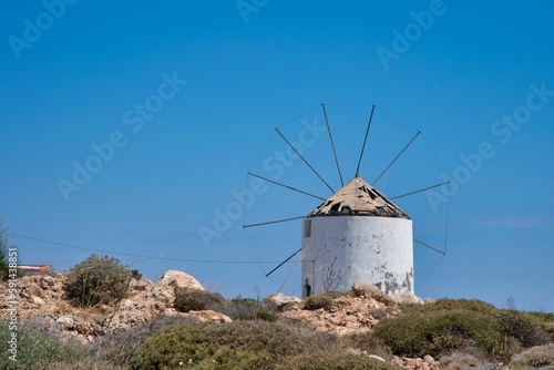 Scenic view of an old windmill in Greece on a summer day in blue sky background
