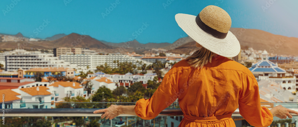 woman standing on balcony and enjoying view to the Playa de las Americas  holiday resort skyline in Tenerife. banner with copy space Stock Photo |  Adobe Stock