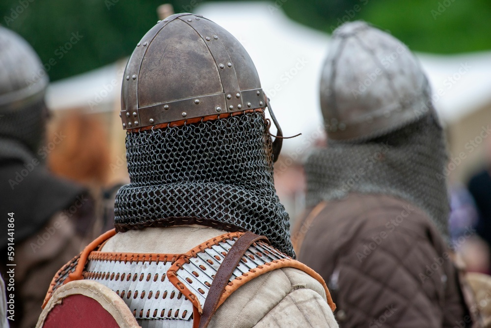 Closeup of a Viking attire and helm on a person standing in a line Closeup of a Viking attire and helm on a person standing in a line