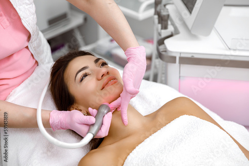 Facial treatment, Rejuvenating facials,Hydro-microdermabrasion,Skin therapy,Rejuvenation treatment,cosmetology procedure. The aesthetician is giving the woman a facial at the spa