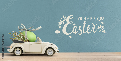 Fotografía Retro cabrio car carrying an easter egg . Happy Easter text