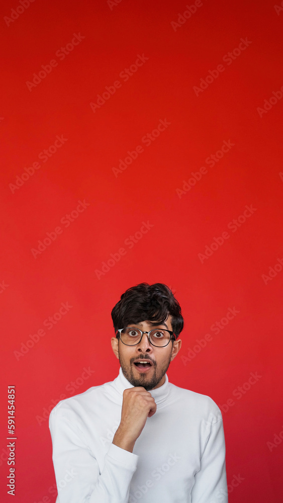 Impressed face. Surprising news. WOW reaction. Inspired amazed curious smart man in glasses with open mouth on red color empty space advertising background. Impressed face. Surprising news. WOW reaction. Inspired amazed curious smart man in glasses with open mouth on red color empty space advertising background.
