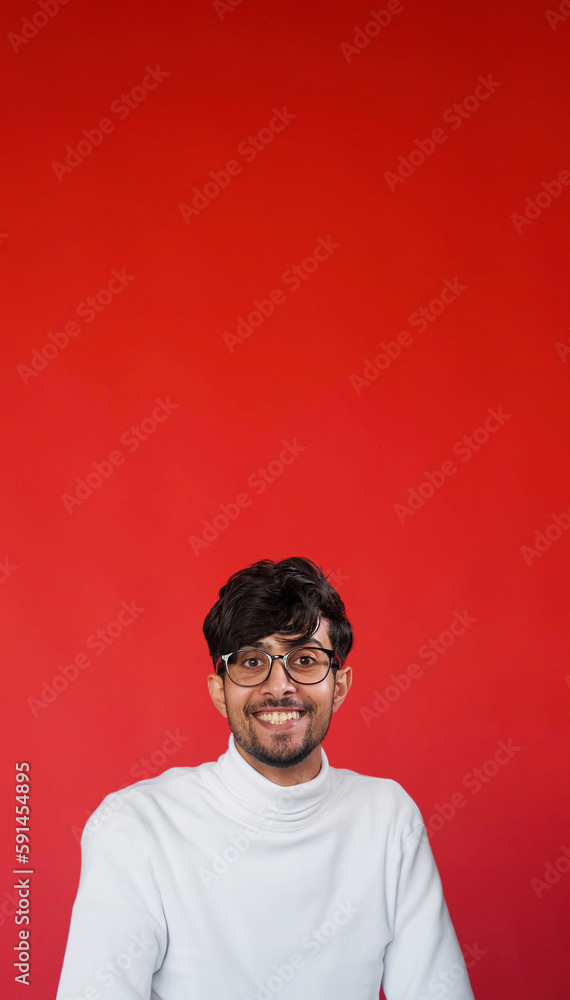 Happy face. Positive emotion. Joy expression. Portrait of optimistic satisfied cheerful smart man in glasses smiling on red color empty space advertising background. Happy face. Positive emotion. Joy expression. Portrait of optimistic satisfied cheerful smart man in glasses smiling on red color empty space advertising background.
