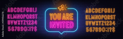 You Are Invited neon sign in the speech bubble on brick wall background.