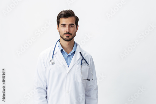 A man doctor in a white coat with a stethoscope and wearing serious glasses on a white insulated background looking into the camera, copy space, space for text, health