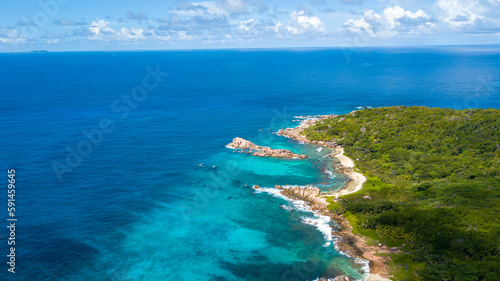 Seychelles Island beaches are a beautiful and secluded destination that offer a range of benefits for travelers. Drone shot over the ocean © Birol