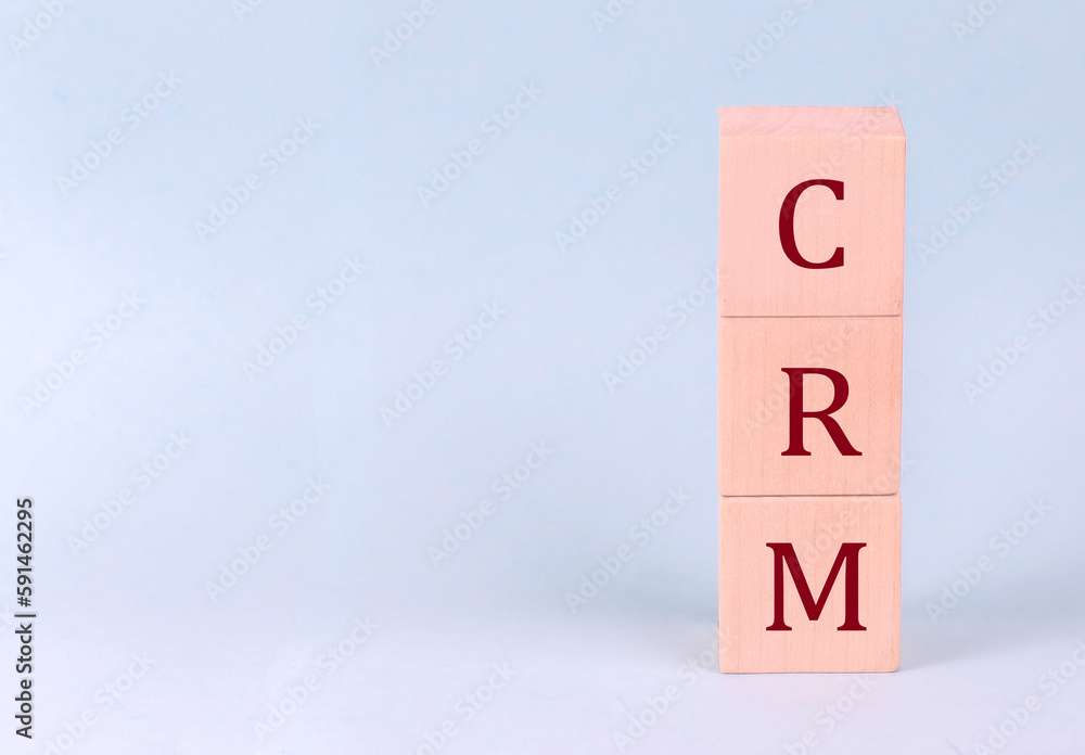 CRM on wooden cubes on a blue background CRM on wooden cubes on a blue background