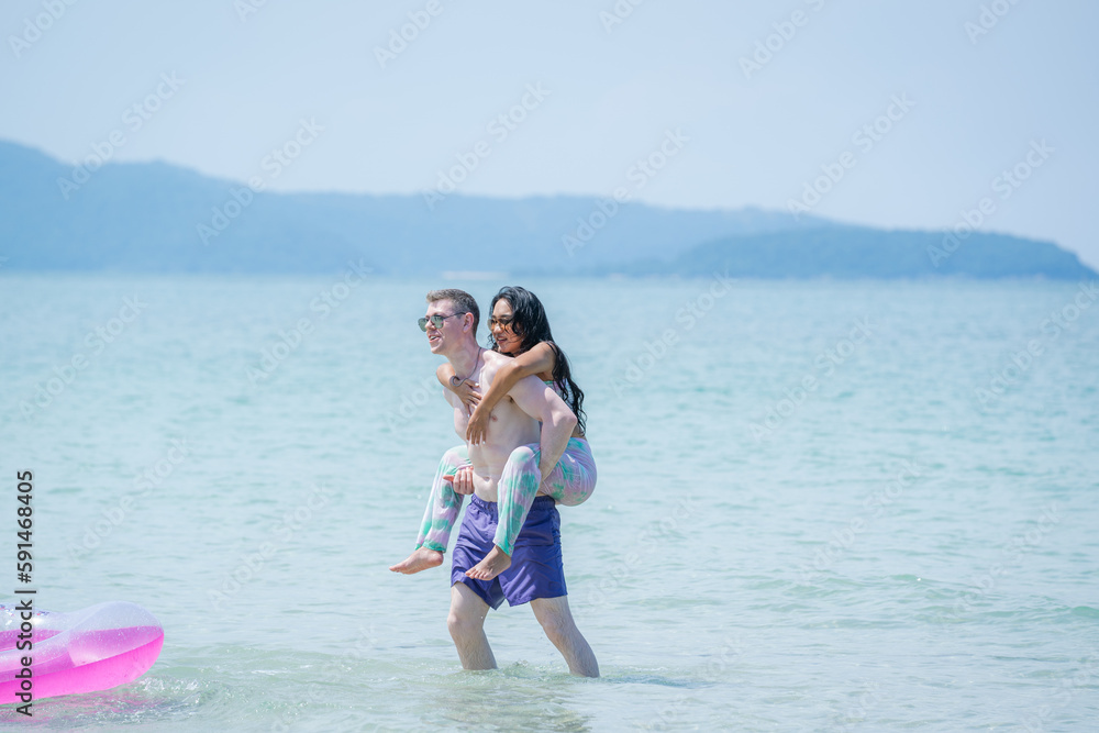 Happy couple together on sea beach,Travel and beach fun and summer vacation or honeymoon. Happy couple together on sea beach,Travel and beach fun and summer vacation or honeymoon.