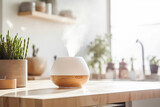 An essential oil diffuser on the bench in a bright well lit kitchen