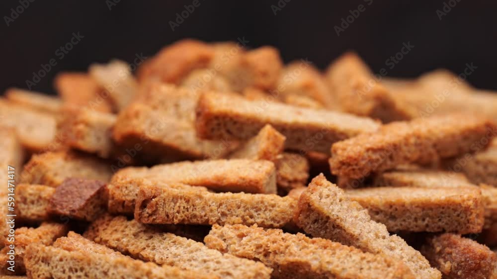Crispy toasted bread croutons. A pile of hard rusks from dark dry bread