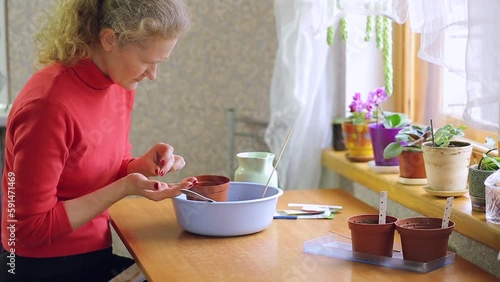 Woman planting seeds in a pot