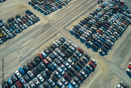 View from above of big parking lot with parked used cars after accident ready for sale. Auction reseller company selling secondhand broken vehicles for repair