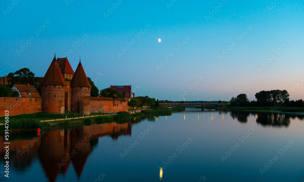 Marienburg castle the largest medieval brick castle in the world in the city of Malbork evening view at night Marienburg castle the largest medieval brick castle in the world in the city of Malbork evening view at night