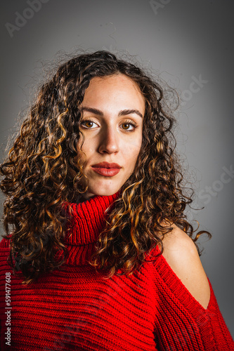 Portrait of a young caucasian girl with long and curly brown hair