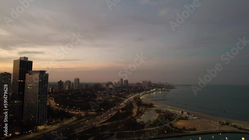 Sunset lakeshore moment during wintertime Chicago. Iconic city of chicago skyline. photo