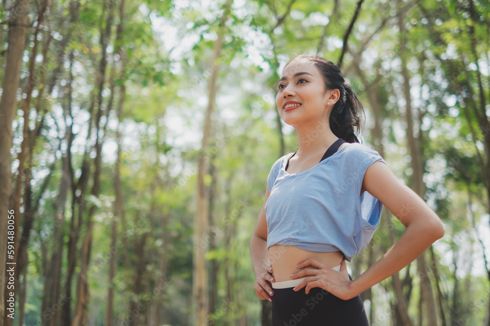 An Asian female is exploring the nature while running. Concept of recreation, Weekend break, discovery, positive energy, happiness, carefree, traveler, Alone and solitude, lifestyle activity freedom. An Asian female is exploring the nature while running. Concept of recreation, Weekend break, discovery, positive energy, happiness, carefree, traveler, Alone and solitude, lifestyle activity freedom.