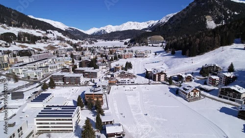 Davos, Switzerland, aerial winter landscape. Residential area covered in snow , Swiss Alps. photo