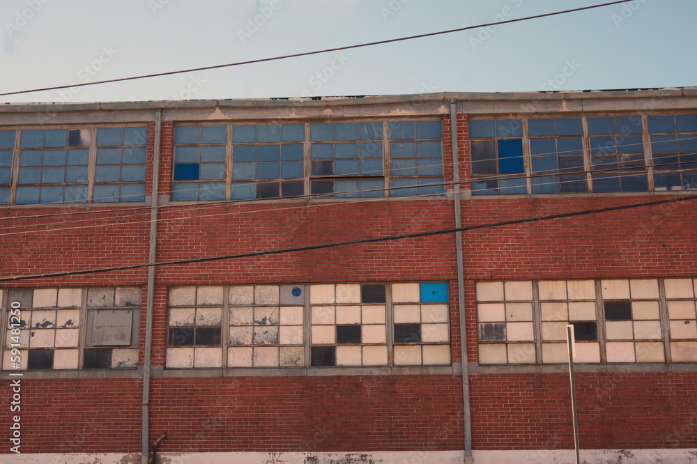 Exterior Factory Wall with Windows Having Mismatched Glass Panes Exterior Factory Wall with Windows Having Mismatched Glass Panes