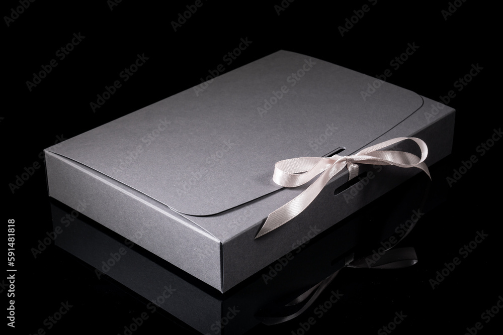 Man gift concept. gift box with luxury bow on dark background. Horizontal with copy space. Man gift concept. gift box with luxury bow on dark background. Horizontal with copy space.