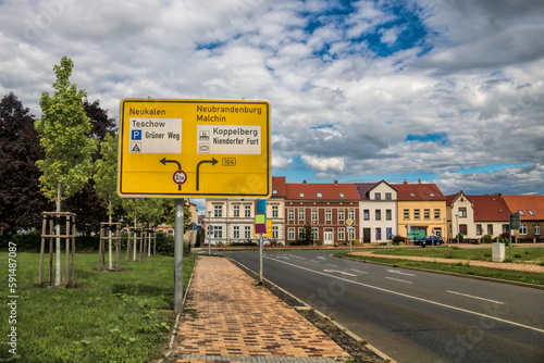 teterow, deutschland - straßenschild am stadteingang mit sanierter häuserzeile im hintergrund photo