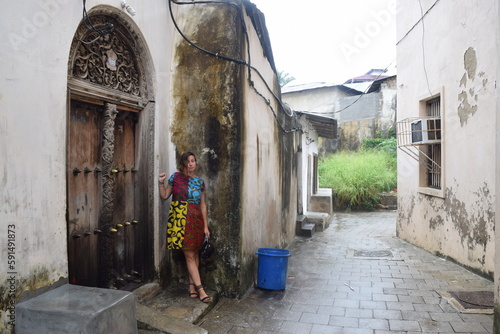 Girl poses with vintage door in Stone Town Zanzibar