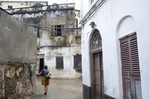 Girl poses with vintage door in Stone Town Zanzibar