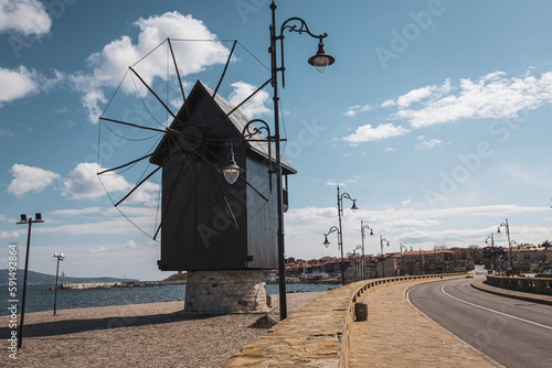 Old wooden windmill at the entrance to Nessebar old town, Bulgaria photo